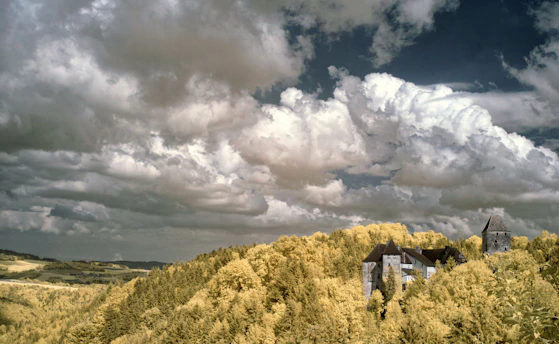 A fantasy landscape with rolling hills and a mystical castle in the distance under a starry sky.