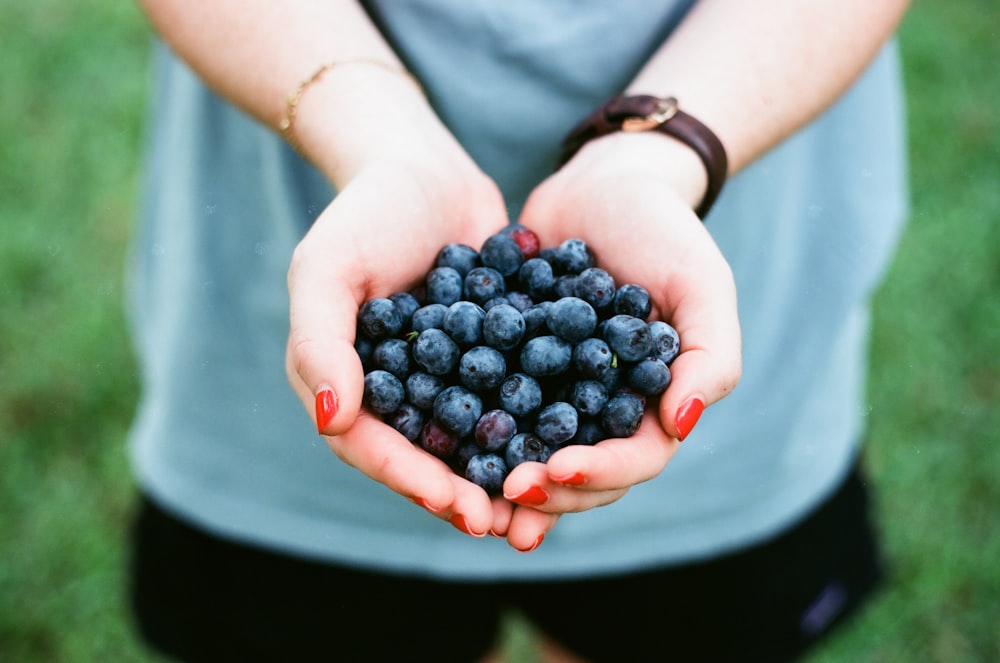 person showing blue berries