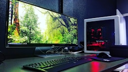 A sleek computer setup displaying an engaging strategy game on screen.