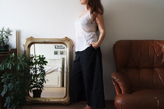 An elegant floor mirror leaning against a stylish accent wall.