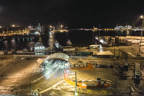 The bustling port of Buenos Aires at sunset with ships and lively waterfront activity.