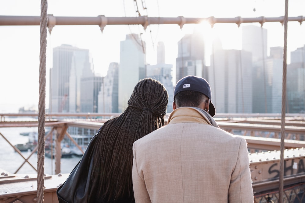 Two people looking down at a building site.