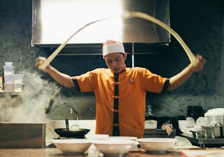 chef making pasta inside kitchen