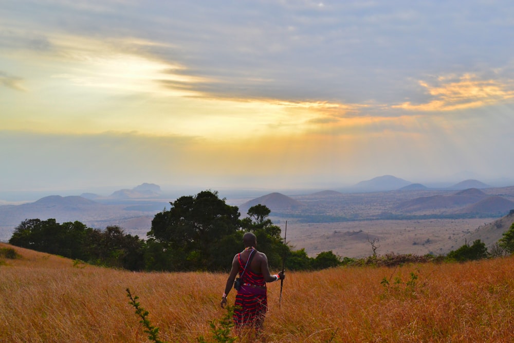 man standing on meadow during day time