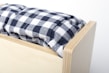 Close-up of a sturdy wooden box spring frame with a comfortable mattress on top.