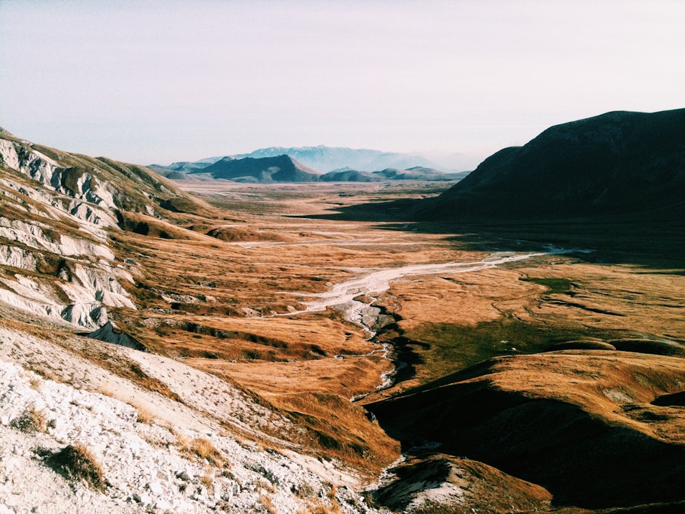 brown field near mountain range