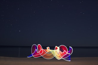 A glowing neon pastel illustration of a celestial compass over ocean waves under a starry sky.