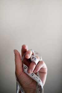 Person's hand wrapped by tape -sub title-Know Good Body Composition-topic-How to Get Lean Mass Body