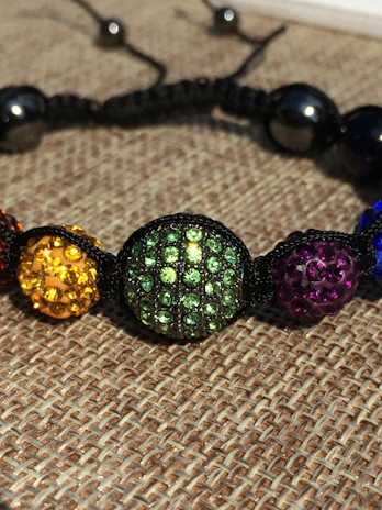 Close-up of colorful handmade bracelets woven with Egyptian loom threads.