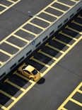 yellow coupe on parking lot at daytime