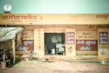 A small shop displaying agricultural products like seeds and fertilizers in a rural setting.