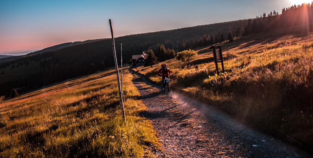 person motorcycling on pathway