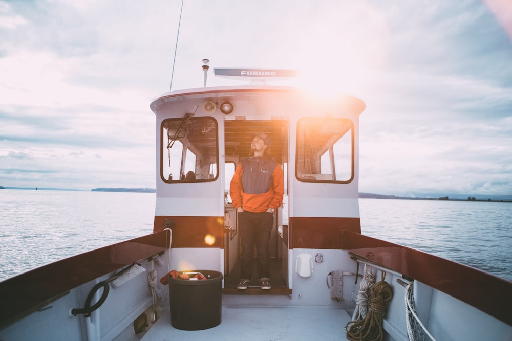 man standing inside sailboat