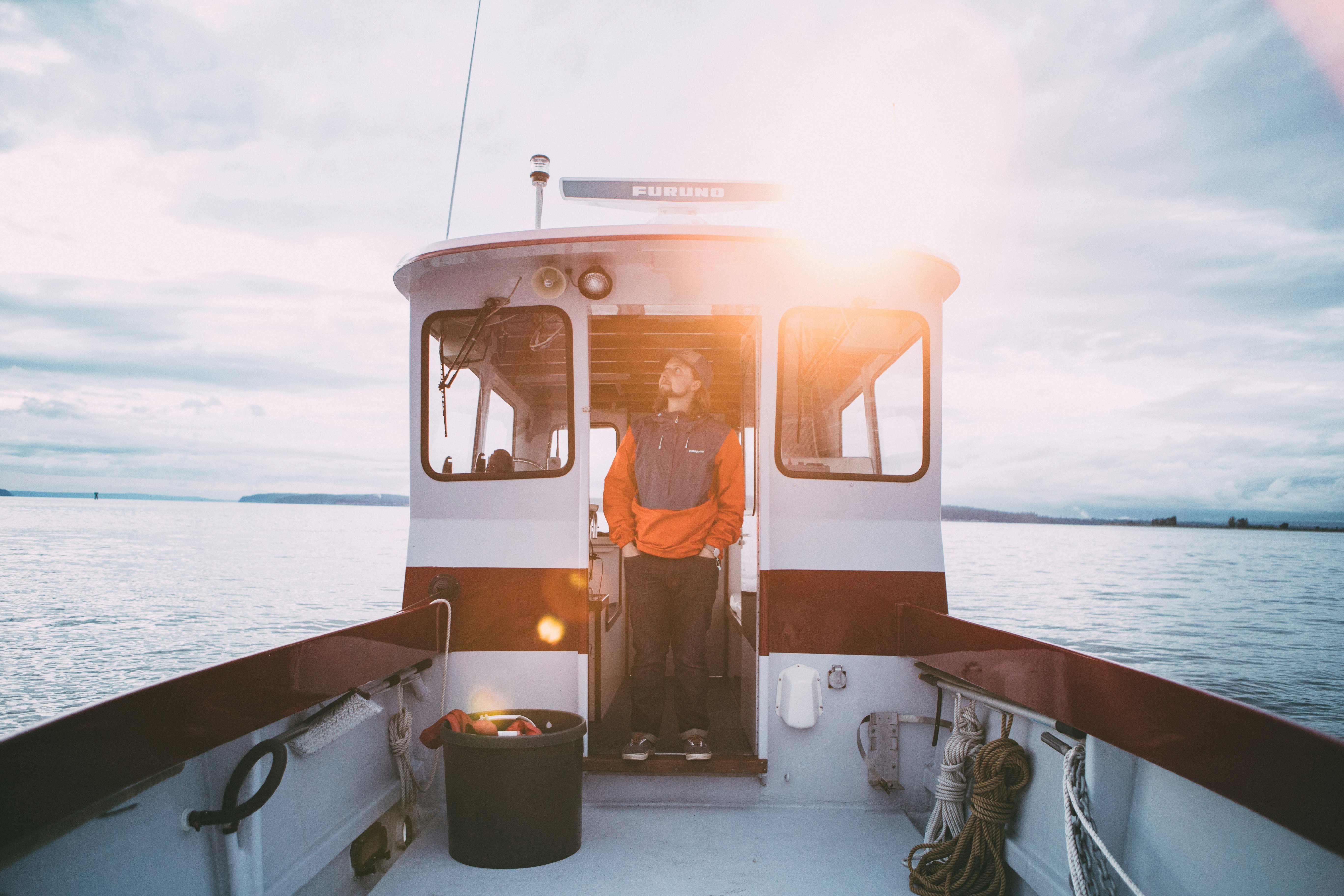 man standing inside sailboat