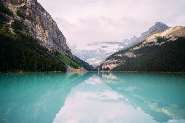 A serene turquoise lake surrounded by towering mountains in Patagonia.