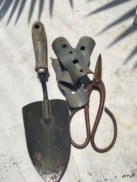 Garden maintenance tools neatly arranged on a wooden bench.