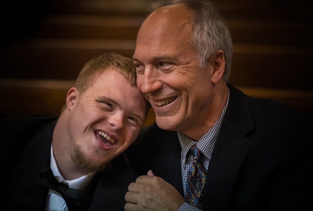 two man smiling on focus photography