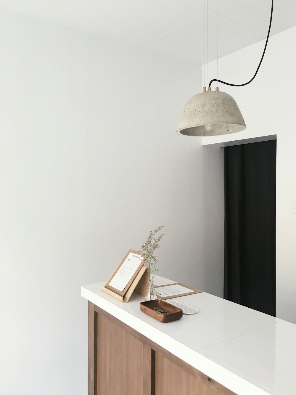 white and brown wooden counter near white wall