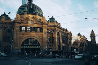 brown building with cars passing infront