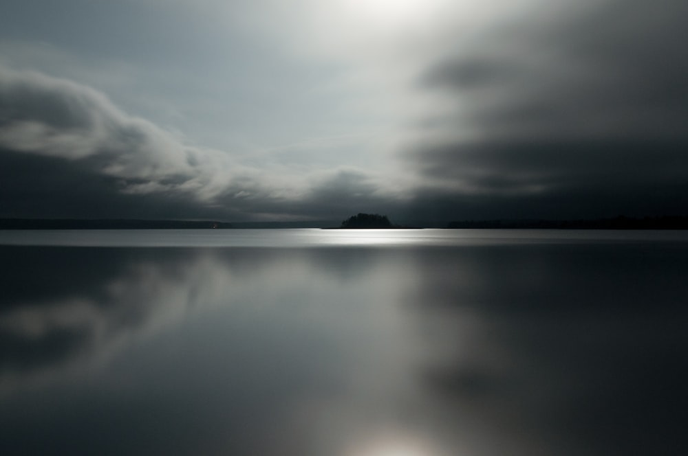 gray clouds reflected on water