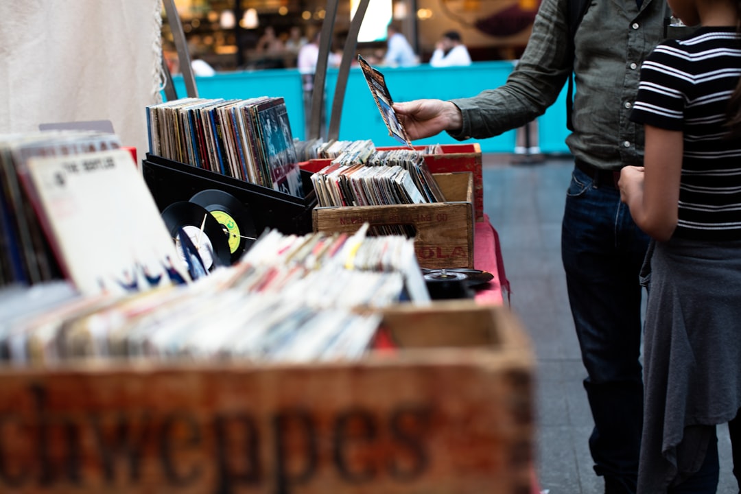 A man and a child browsing vinyl records from vintage boxes