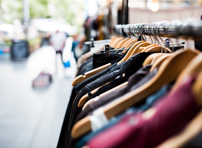 selective focus photography of hanged clothes