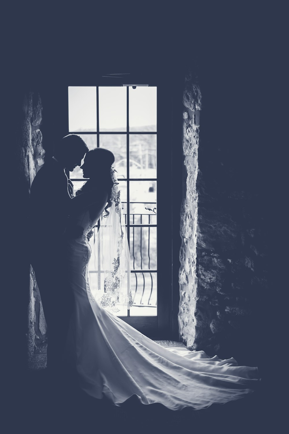 Grayscale of bride leaning into her husband at Cambridge Mill