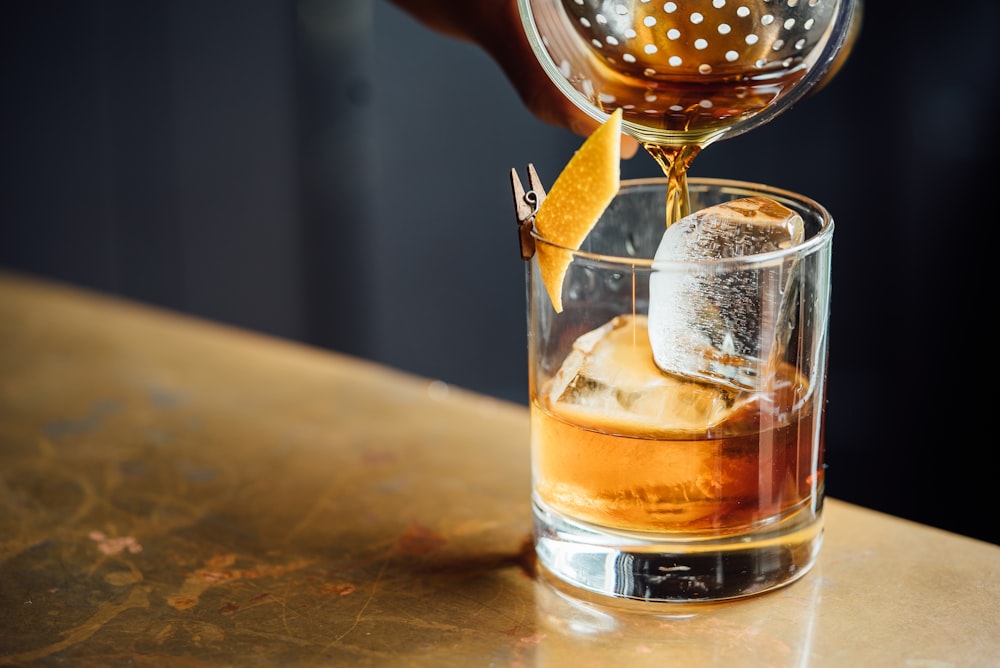 liquor pouring on clear shot glass