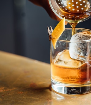 liquor pouring on clear shot glass