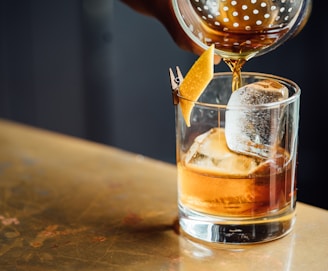 liquor pouring on clear shot glass