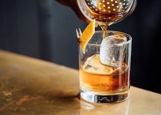 liquor pouring on clear shot glass