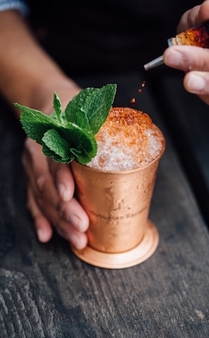 brass-colored cup filled with crushed ice with mint