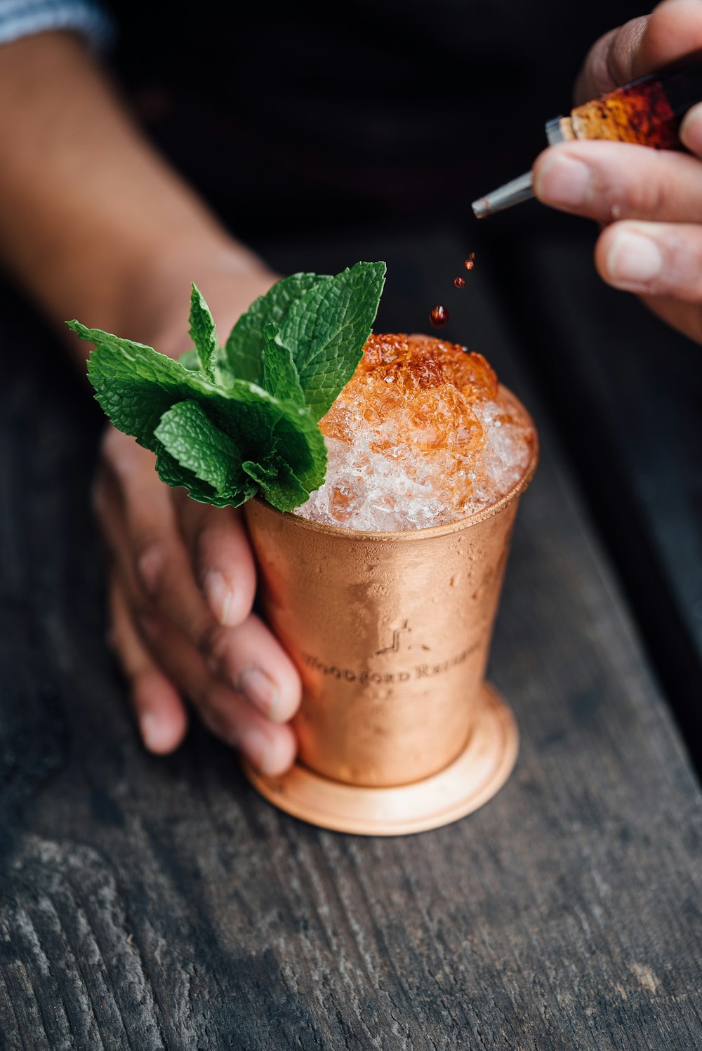 brass-colored cup filled with crushed ice with mint