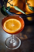 orange slice in a wine glass full of orange liquid