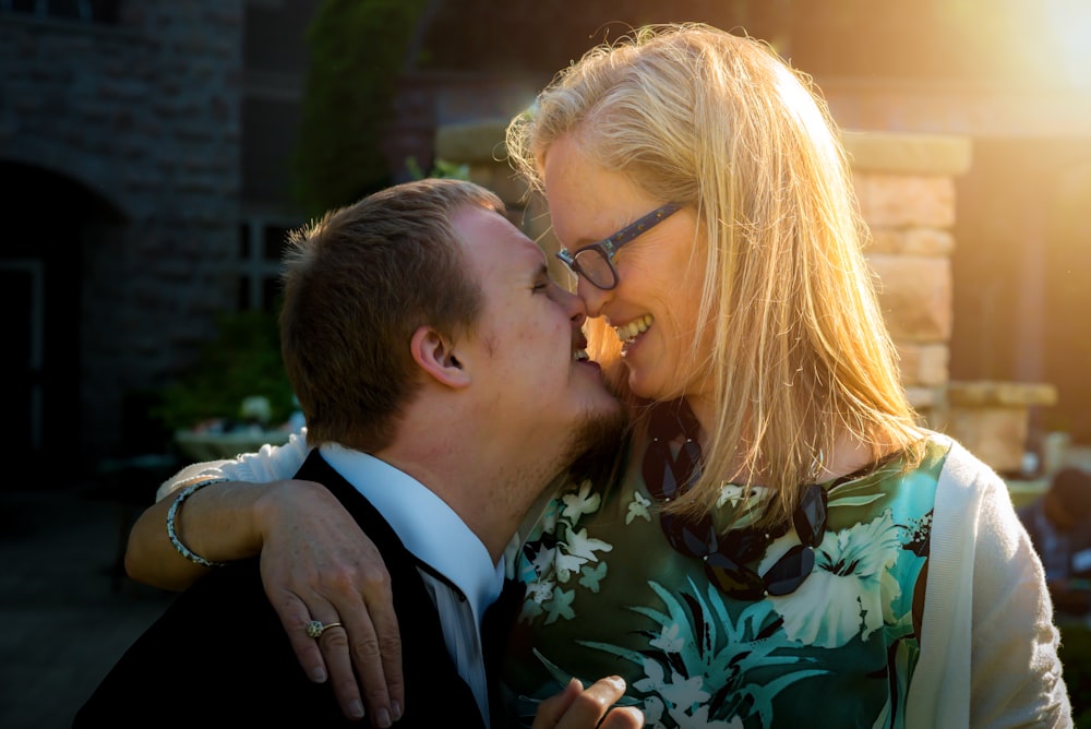 smiling couple kissing during daytime