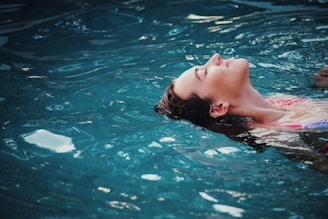 woman floating on body of water