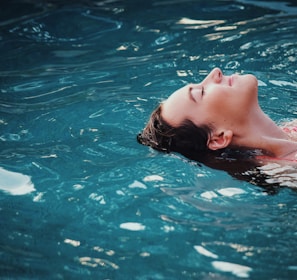 woman floating on body of water