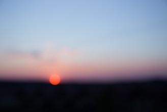 A blurred image of a sunrise over the ocean symbolizing new beginnings.