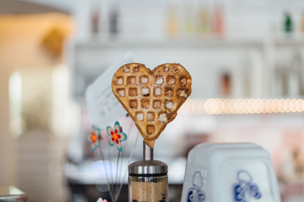 A waffle in the shape of a heart is displayed at a bright shop in Maybachufer