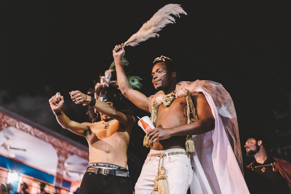 two topless men performing