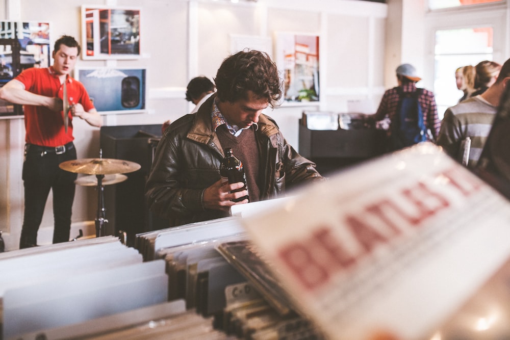 Young people browsing the vinyls at a record score
