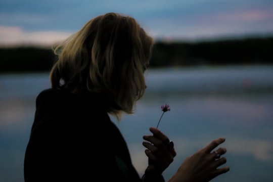 woman holding flower in Long Lake Recreation Area United States