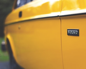 close up photography of yellow Volvo car