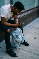 man sitting while using phone