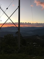 A panoramic view of Big Sky Montana landscape with antenna towers silhouetted against the sunset