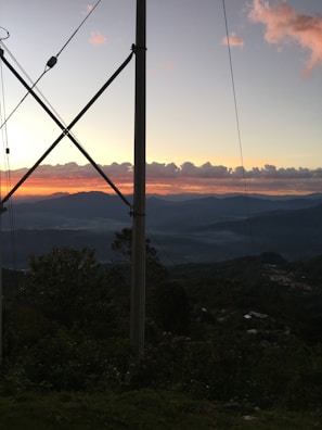 A panoramic view of Big Sky Montana landscape with antenna towers silhouetted against the sunset