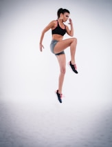 woman jumping near white wall paint