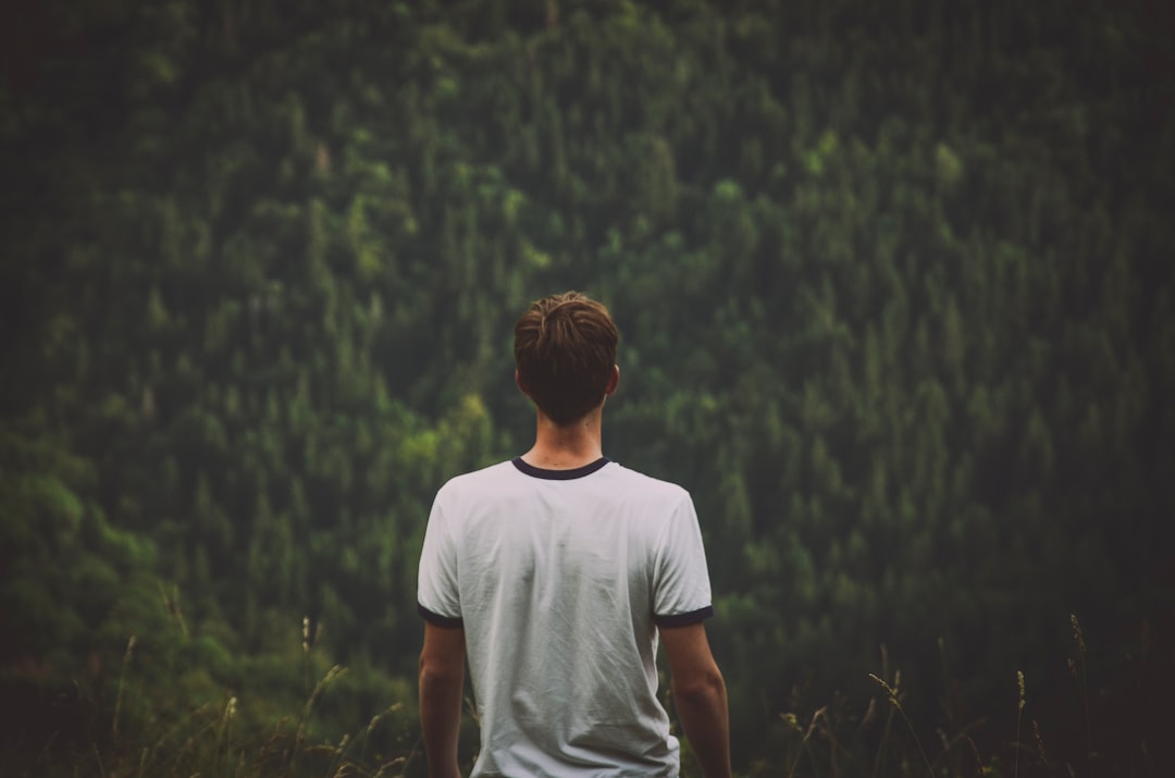 Man in a t-shirt over a forest