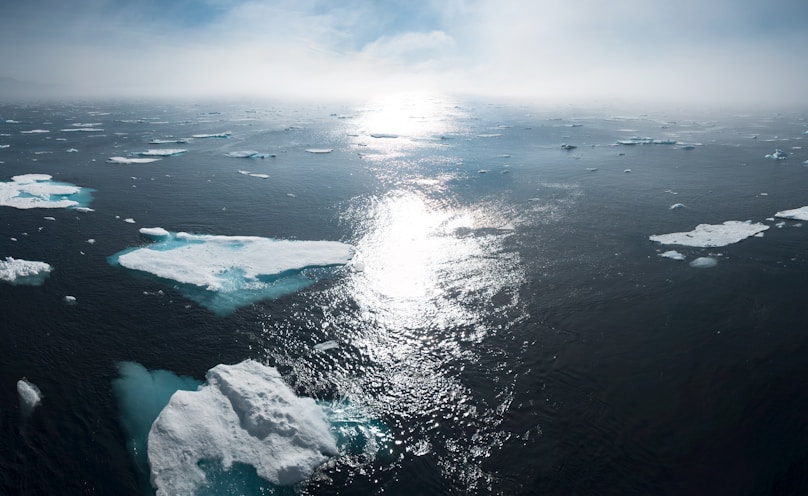 landscape and aerial photography of icebergs on body of water during daytime