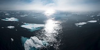 landscape and aerial photography of icebergs on body of water during daytime